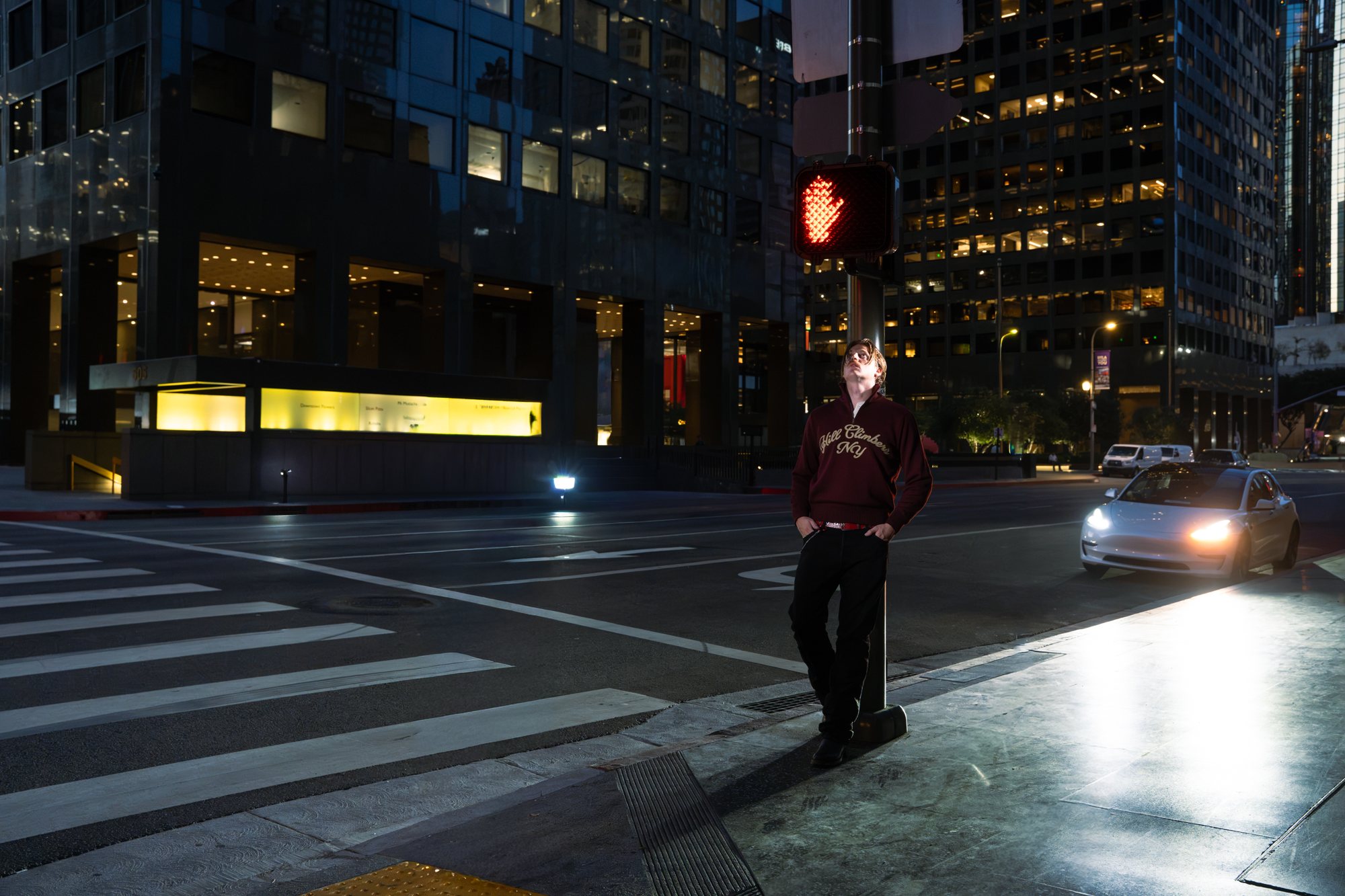 campthehills leaning against a crossing signal on an empty downtown Los Angeles street at night.